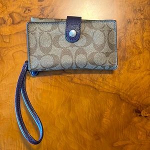 Brown leather coach wristlet with purple trim
